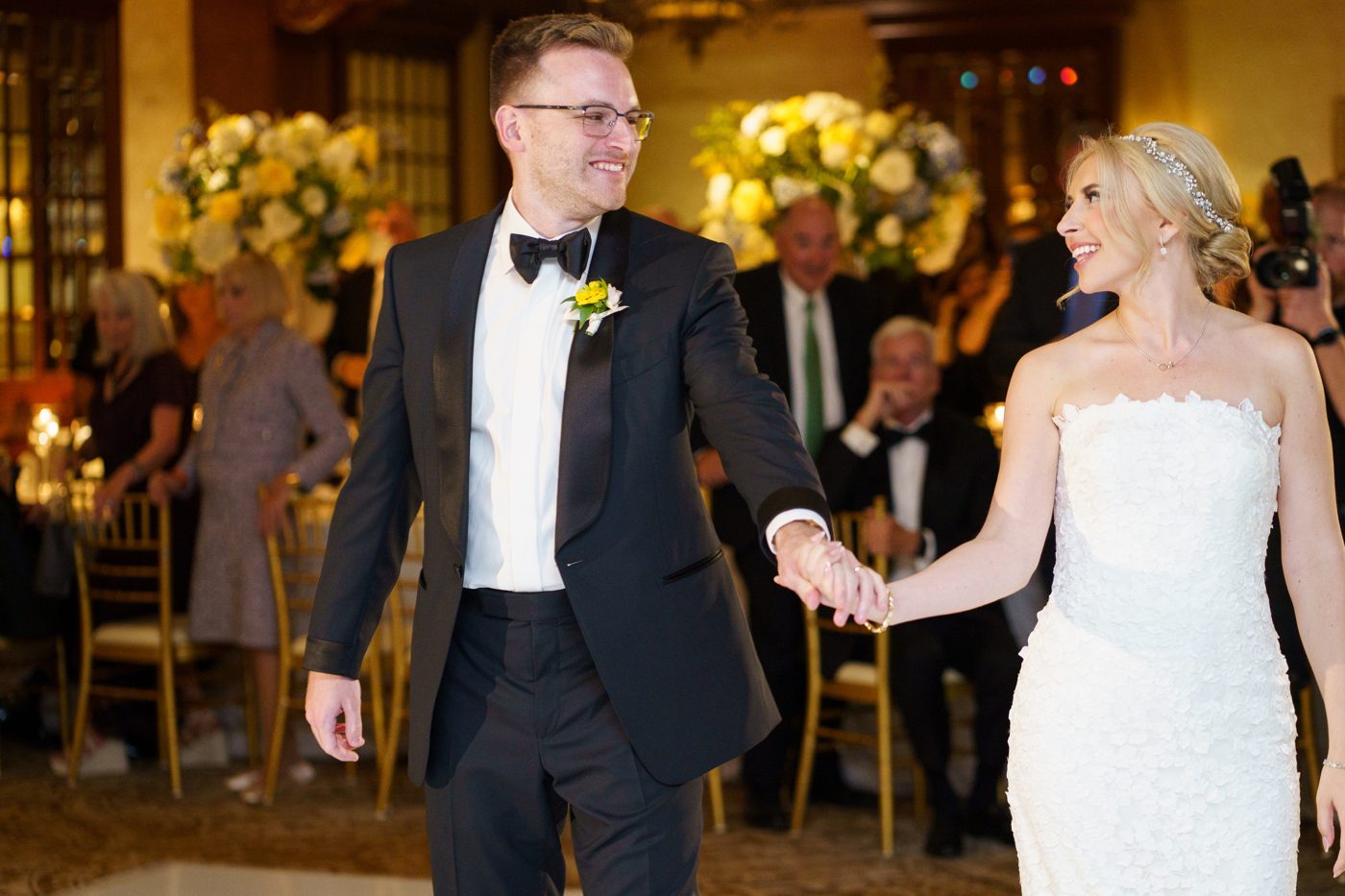 Abbey and Benjamin walking onto the dance floor for their first dance