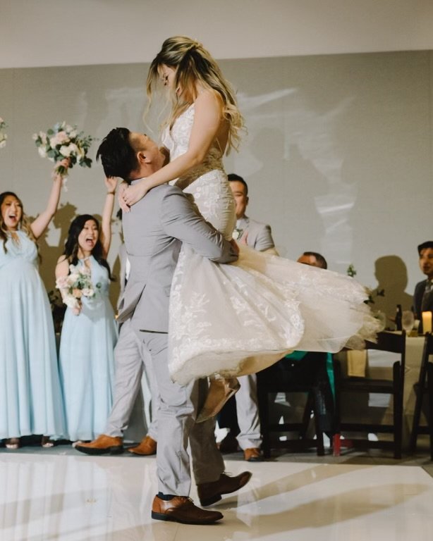 Kelley and John first dance lift with their wedding party